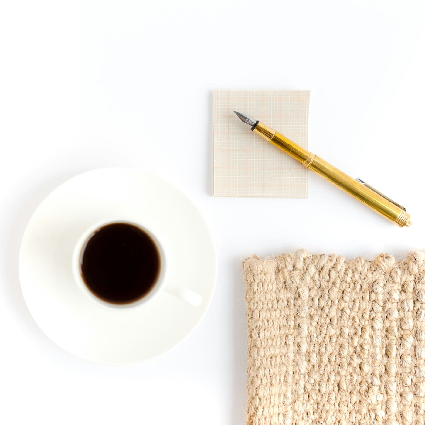A refined studio flat-lay with branding materials, florals, and a candle